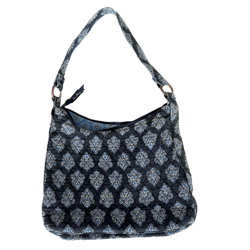 Vera Bradley denim look shoulder bag has two exterior zip pockets